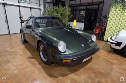 Green Porsche 911 SC 3.0 Targa from 1980 at a dealer in Italy